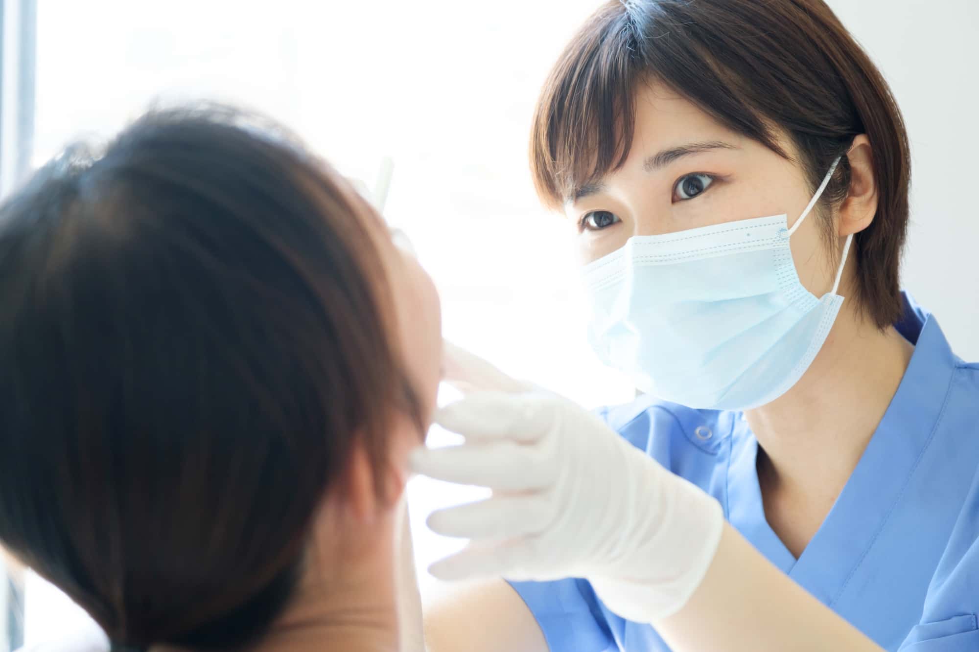 親知らずが痛んで歯科医にみてもらう患者